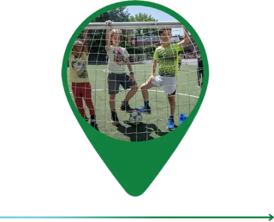 A green pin with people playing soccer on it