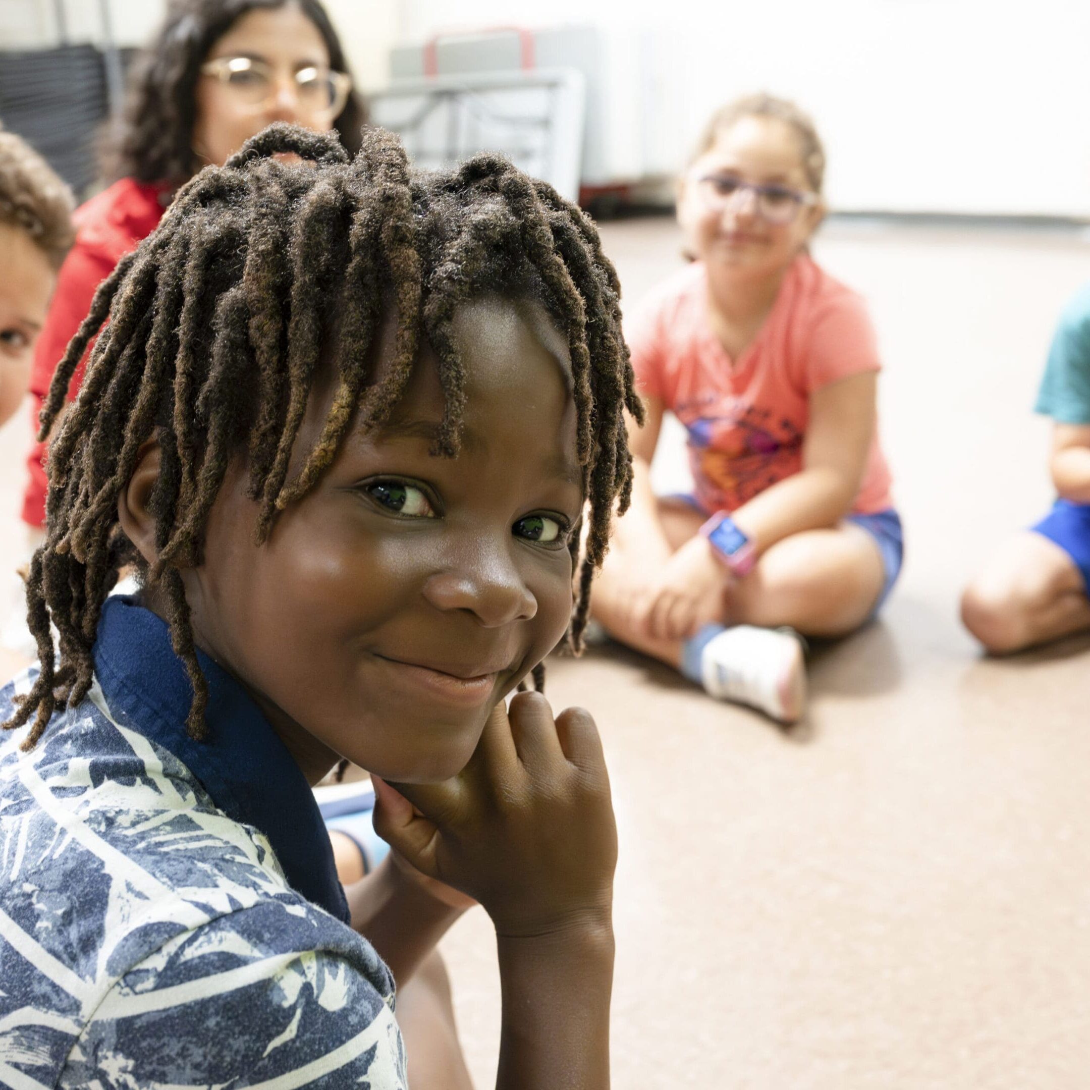 A group of children sitting on the floor.